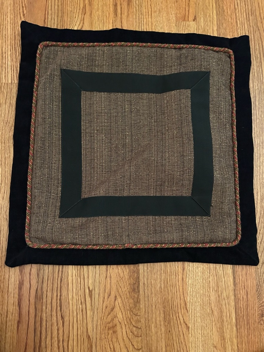 Custom-made square pillow covers Center panel in textured brown w black trim.